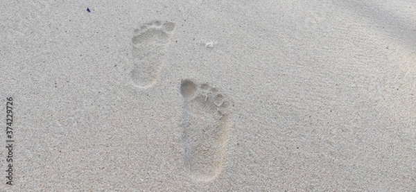 Fototapeta footprints in the beach sand