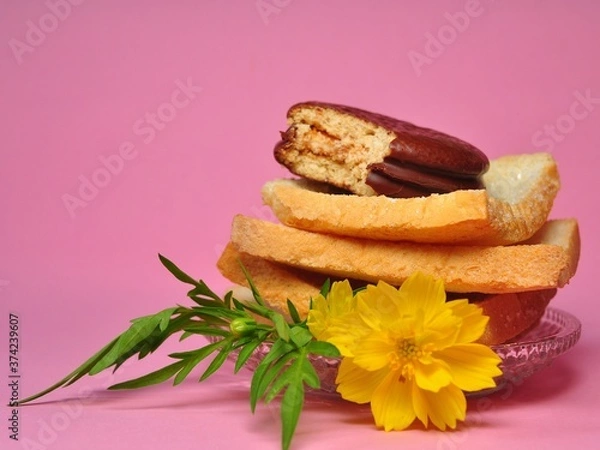 Obraz Dry rusk bread and choco pie chocolate on pink background. Healhty breakfast menu