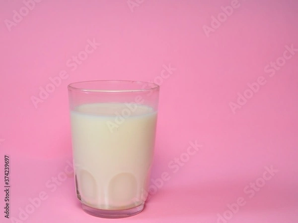 Obraz A glass of milk isolated on pink background. Fresh milk