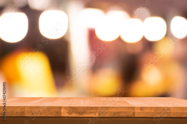 Fototapeta Product display on brown wooden table Bokeh background from the bulb shop