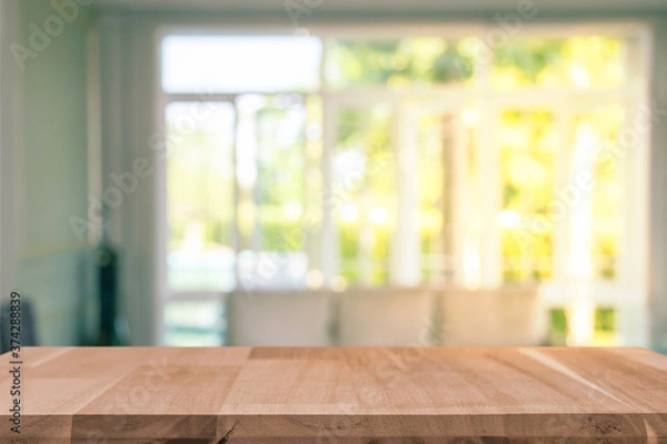 Fototapeta Display products on a brown wooden table in a bright white room in the morning