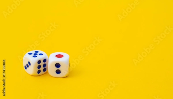 Fototapeta Two game cubes are laid out on a yellow background: entertainment, games at home for the whole family, the concept of Board games. Table game, text space