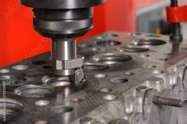 Obraz A machine for grinding car valves is being set up in the workshop.