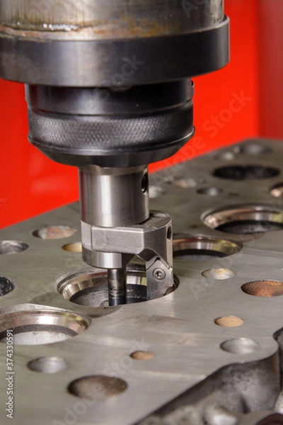 Obraz A machine for grinding car valves is being set up in the workshop.