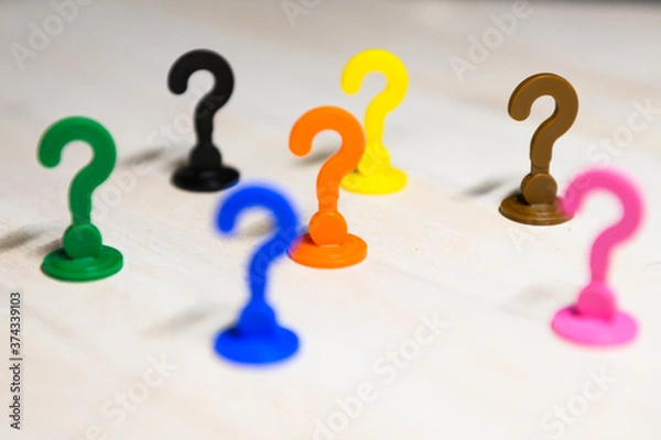 Fototapeta Problem solving and leadership illustrated with play figures in question mark shape in bright colors against white background.