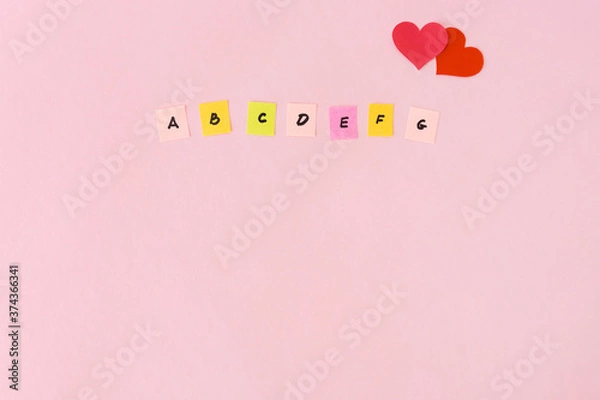 Obraz Letters english alphabet and hearts near. Love for the languages. Multicolored papers with the abc. Studying of foreign, school lessons. Copy space, place for text. Flat lay.