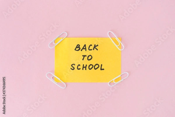 Obraz Back to school. Text on note with white paper clips in the corners. Message on post. Concept beginning of the school year. Information on notice.