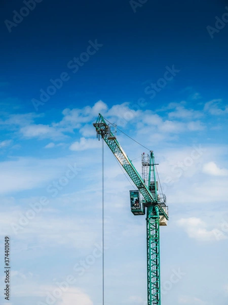Obraz Crane against a blue sky.