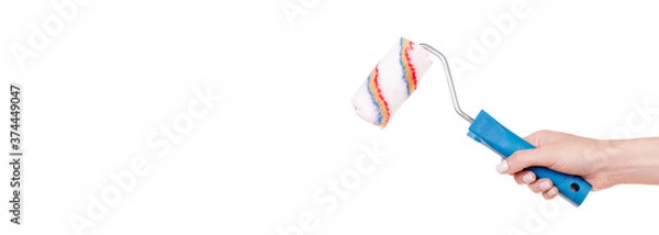 Fototapeta Hand with striped wool paint roller, home decoation and improvement. Isolated on white background, copy space template, banner.