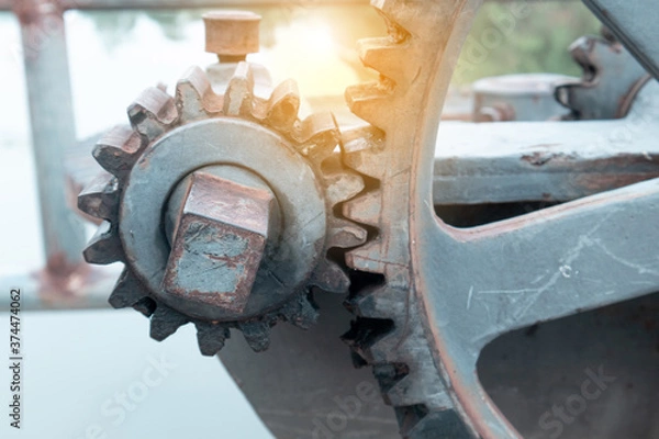 Fototapeta Close up large gears of the floodgate are mounted on an outdoor concrete base, used to control the opening and closing of the floodgate of a dam, reservoir or large waterway.