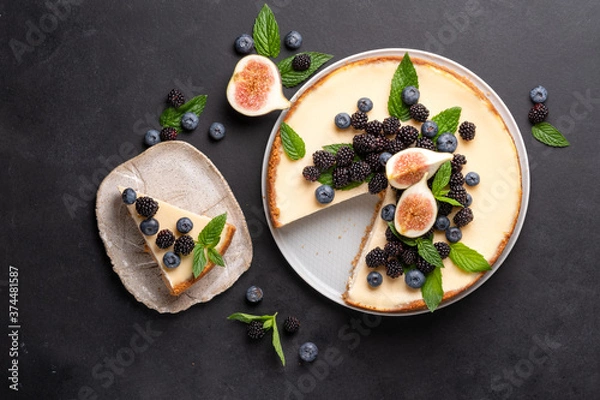 Obraz Cheesecake slice, New York style classical cheese cake on black background. Slice of tasty cake on white plate 