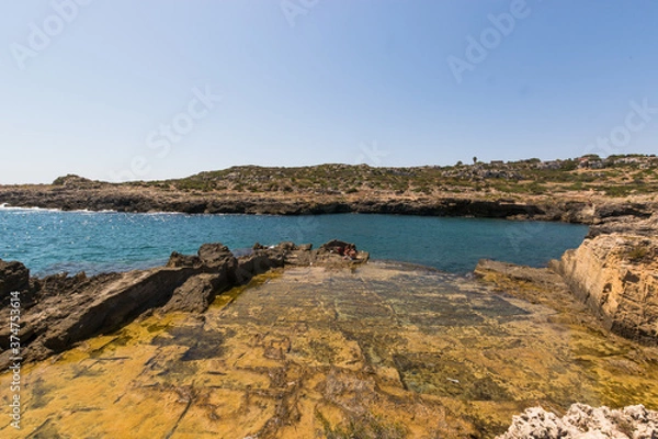 Fototapeta Beautiful Natural pool created by the rocks, Historical coast of Siracuse, Sicily, Italy.