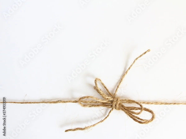 Fototapeta Handmade bow made of natural jute rope at the bottom - decoration for wrapping gifts