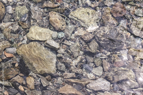Fototapeta Crystal clear water in a mountain river