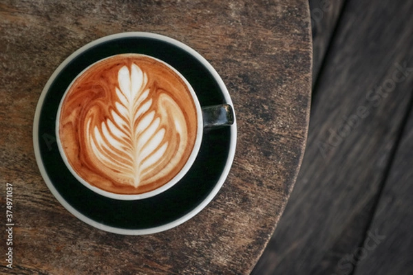 Fototapeta A cup of coffee with latte art on top