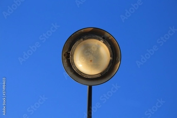 Fototapeta antique lamppost taken from the bottom upwards. Roundish concentric and symmetrical shape stands out against the celestial background