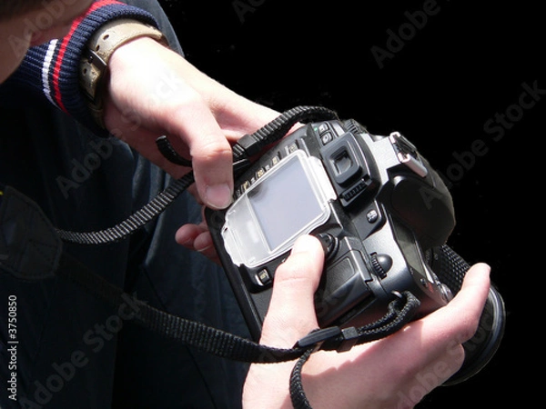 Obraz Black digital camera on hands photographer