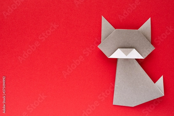 Obraz gray origami cat on red background