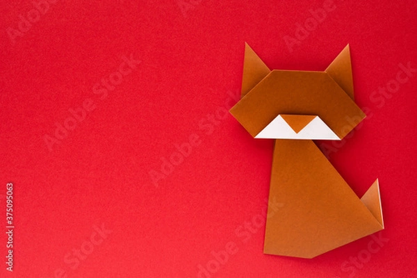 Obraz brown origami cat on red background