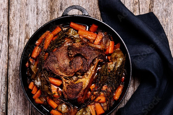 Fototapeta Braised beef brisket big piece with carrots and onion sauce serve in a hot pan