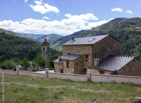 Fototapeta image of the parish church san martin de los oscos with a background of mountains and clouds