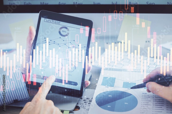 Obraz Multi exposure of man's hands holding and using a phone and financial chart drawing. Market analysis concept.