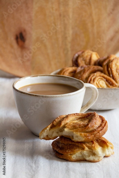 Fototapeta close-up of sweet pastries with a cup of coffee on the table on a wooden background