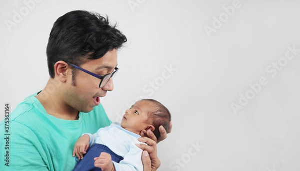 Obraz a father making funny face at his baby isolated in white background with space for text