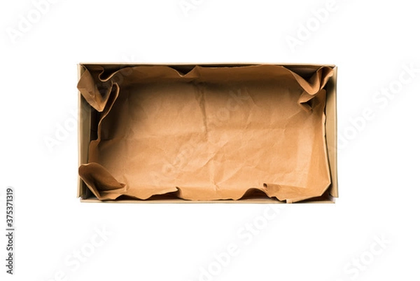 Fototapeta Shoe box isolated on a white background. Open cardboard box for shoes or gift with crumpled brown paper. Concept of delivery of goods, purchases via an online store