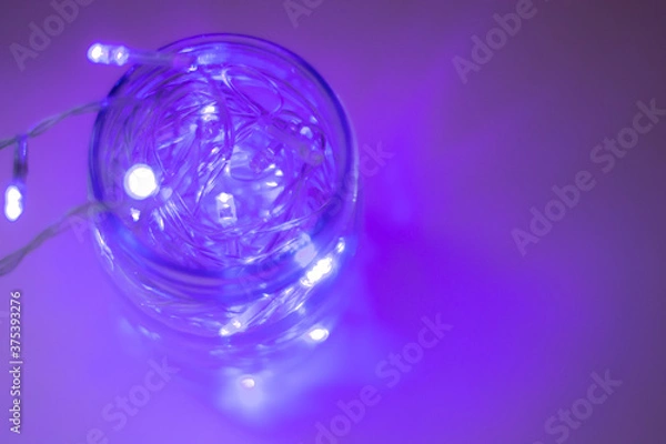 Fototapeta Lights inside the glass jar, colorful light glowing in the dark inside the jar. selective focus
