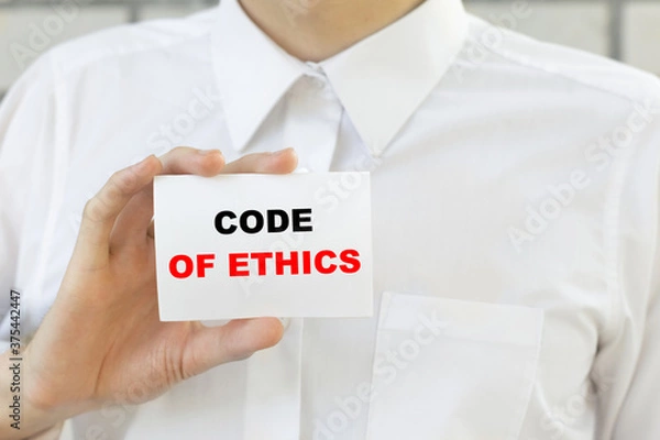 Obraz Businessman putting a card with text CODE OF ETHECS in the pocket