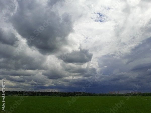 Fototapeta storm clouds over the field