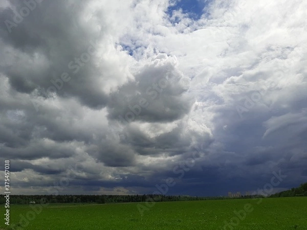 Fototapeta clouds over the field