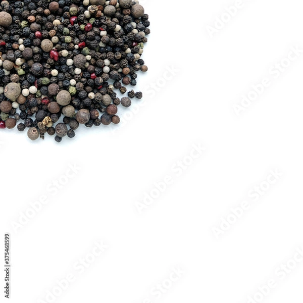 Fototapeta A handful of different types of pepper close-up isolated on a white background.  Assorted Pepper Peas. Background for inserting text or images, free space.