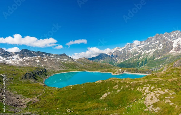 Fototapeta Artificial lake for hydroelectric power plant surrounded with mountains.