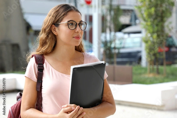 Fototapeta Pretty female college student going to attend class