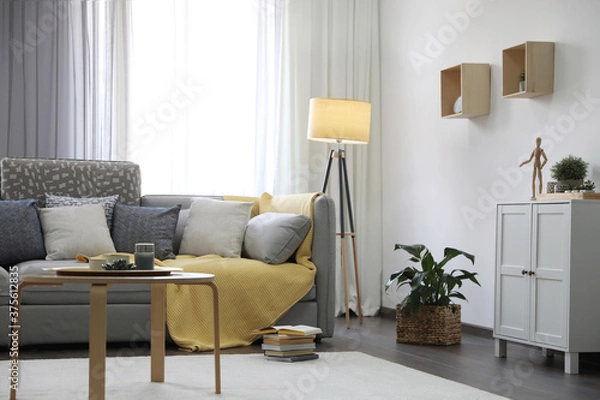 Fototapeta Elegant living room with comfortable sofa near window. Interior design