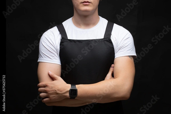 Obraz A young, muscular guy in an apron.