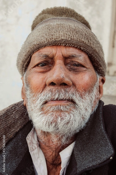 Fototapeta Portrait of an Old Indian man staring directly at the camera