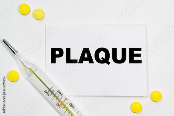 Obraz PLAQUE text written on a white business card next to yellow tablets and a thermometer. Medical concept.