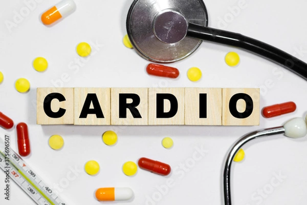Fototapeta CARDIO word on wooden cubes on the background of syringe, tablets, ampoules. Medicine concept.