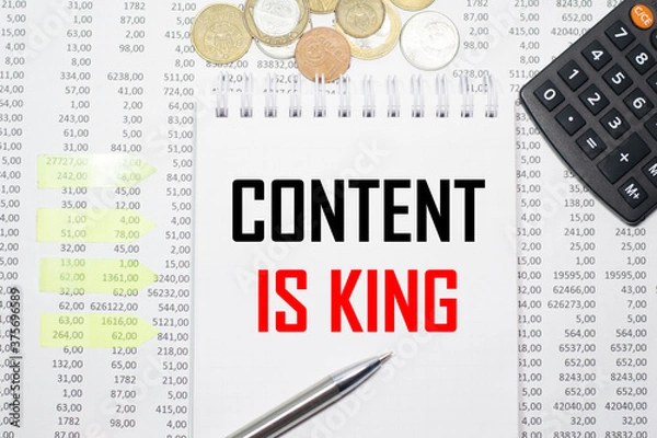 Obraz CONTENT IS KING on the block on the background of financial reporting, coins, calculator, pens and yellow stickers. Business concept
