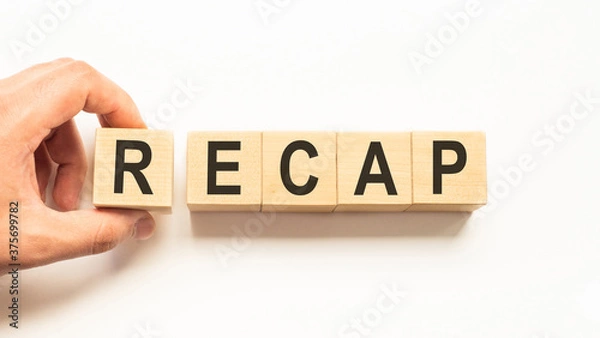 Fototapeta Word recap. Wooden small cubes with letters isolated on white background with copy space available.Business Concept image.