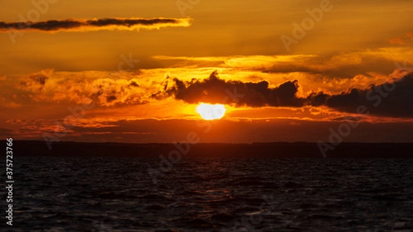 Fototapeta sunset in yellow and red tones over the Volga