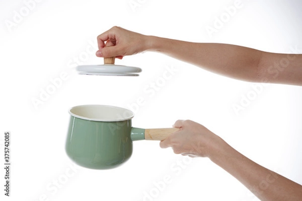 Obraz hand holding pot lid.