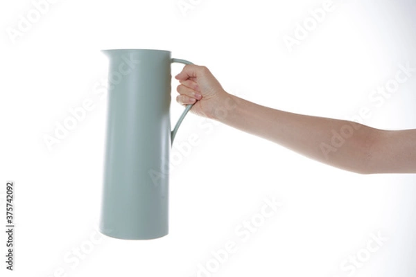 Fototapeta a hand holding a bottle of water.