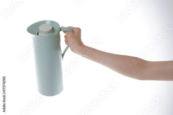 Fototapeta a hand holding a bottle of water.