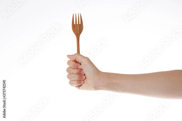Obraz hand holding wooden fork.