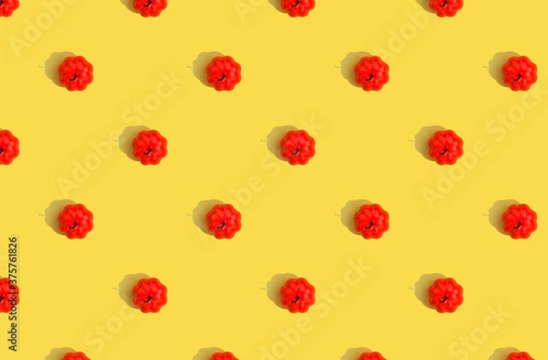 Fototapeta Pumpkin pattern on yellow background with deep shadows.