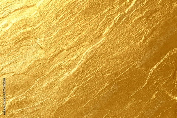 Fototapeta Details of golden texture background. Gold color painted on cement wall for background and wallpaper. Metal texture background in gold. Shiny yellow leaf gold foil texture background. Gold paint.